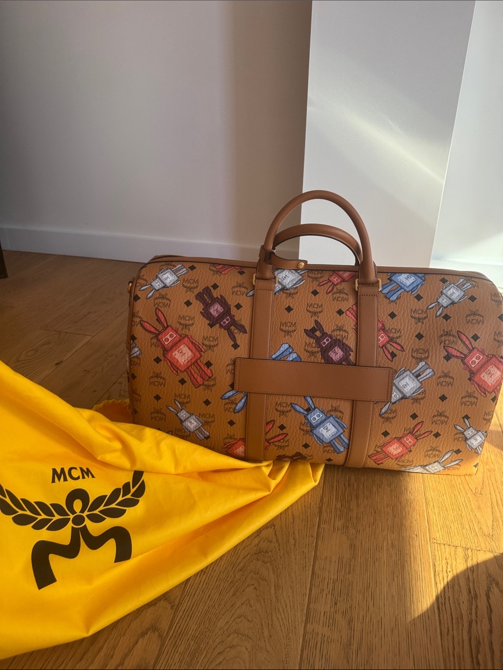 Brand New MCM Cognac Visetos Weekender with Multicolor Perfume Bottle Print.